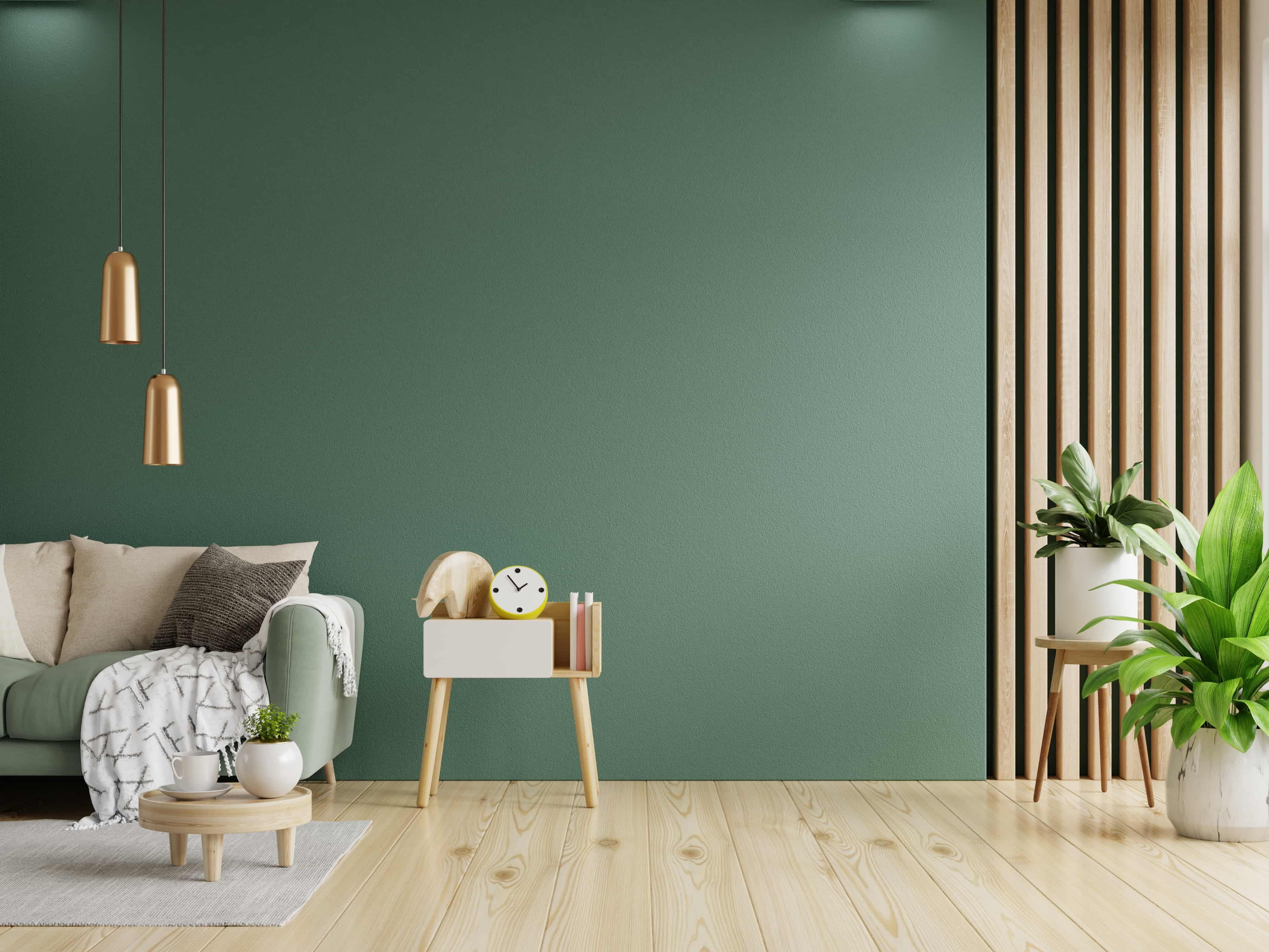 Green-sofa-with-table-on-green-wall-and-wooden-flooring