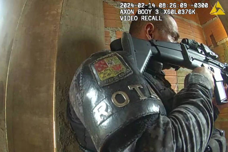 Câmera corporal mostra momento em que um soldado da Polícia Militar coloca luva, logo antes de mexer no corpo e supostamente encontrar a arma de um homem morto pela Polícia Militar na Operação Verão, em Santos, no litoral paulista. (Foto: Reprodução)
