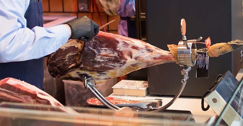 Homem cortando um Jamon Ibérico