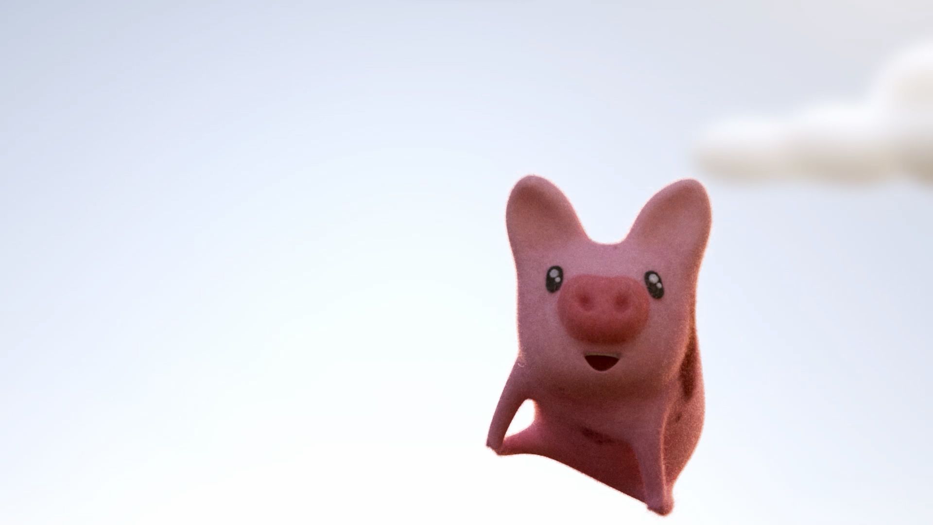 Fotografia colorida de miniatura de porquinho cor-de-rosa com orelhas pontudas, focinho arredondado e express&atilde;o sorridente. Fundo claro e desfocado. 