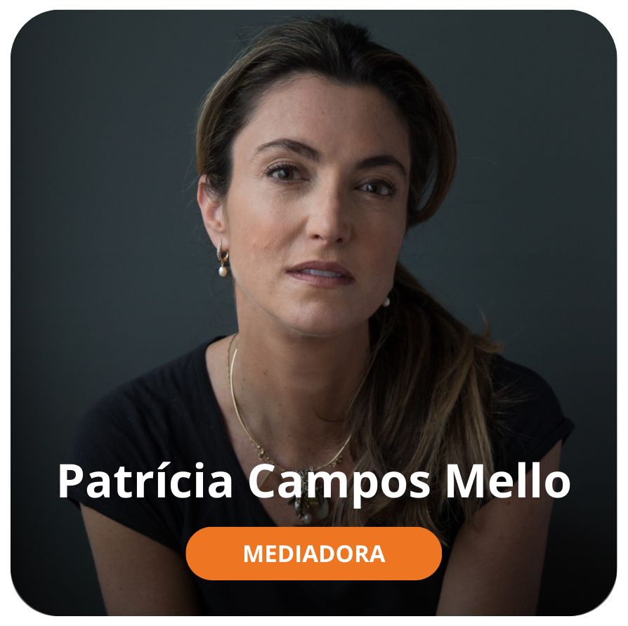 Uma mulher branca, de cabelos lisos, longos e com algumas mechas loiras. Ela est&aacute; sentada, olhando em dire&ccedil;&atilde;o &agrave; c&acirc;mera. O fundo da &eacute; uma parede na cor cinza